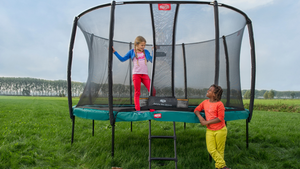 Kids playing on a River City Play Systems trampoline.