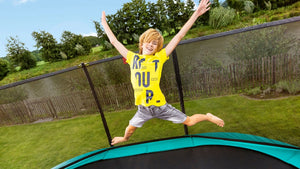 Kid jumping and having fun on a BERG Trampoline.
