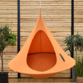 Orange hanging pod chair in a room with wooden walls and potted plants.