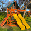 Children's playground with yellow slides on a grassy area
