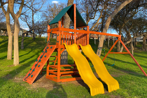 Children's playground with yellow slides on a grassy area