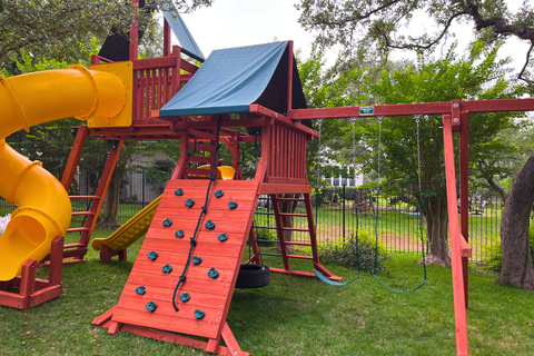 Colorful playground with slides and climbing wall in a park setting