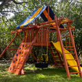 Colorful playground set with slides and swings in a backyard setting.