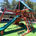Colorful playground structure with slides and climbing areas on a sunny day.