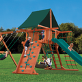 Children playing on a wooden playground set with green slide and climbing structure.